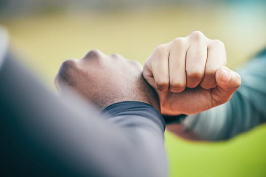 Hands, fist bump and sports teamwork for motivation, collaboration and success. Team building, support and people, man and woman together for workout, training targets and exercise goals outdoors