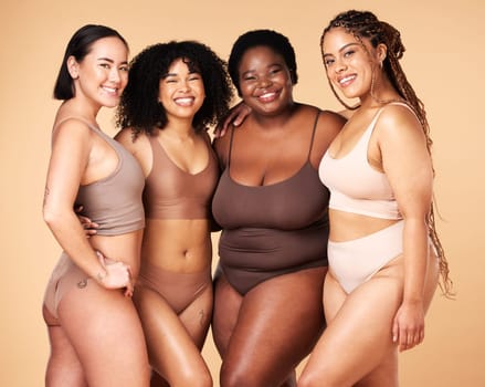 Body, diversity and portrait of different women group hug for inclusion, beauty and skincare. Aesthetic model people or friends on beige background with glow, underwear and motivation for self love.