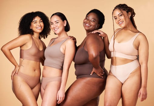 Diversity, happy woman and body portrait of group together for inclusion, skin beauty and power. Underwear model friends on beige background for positivity, pride and motivation support for self love.