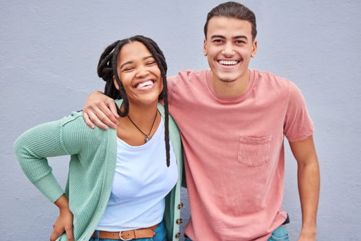 Love, romance and portrait of a happy couple by a wall in the city while on a vacation or weekend trip. Happiness, smile and interracial man and woman embracing while walking in town on a holiday