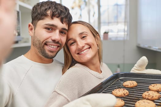 Kitchen, selfie and couple baking cookies together for love, bonding and romance at home. Bake, smile and portrait happy man and woman preparing biscuits or snacks for fun, event or dessert at house