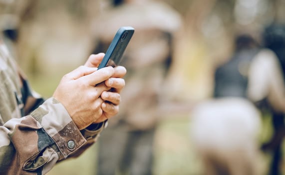 Soldier, hands and phone texting in communication for social media, networking or conversation at war. Hand of person holding mobile smartphone on app in the army for discussion, chatting or contact.