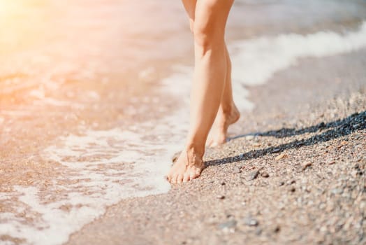 Barefoot woman standing in sea, summer vacation on beach resort. Naked female legs in transparent calm water