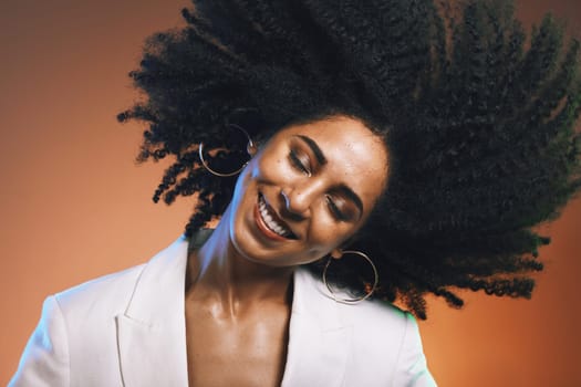 Hair, afro and black woman, beauty with smile on face and cosmetic and hair care with happiness against studio background. Dance, natural curly hair texture and makeup with earrings and freedom.