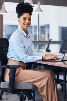 Black woman, business and portrait with a laptop in office while working and typing online. Young entrepreneur person writing an email or report for legal communication and advice on internet or web.