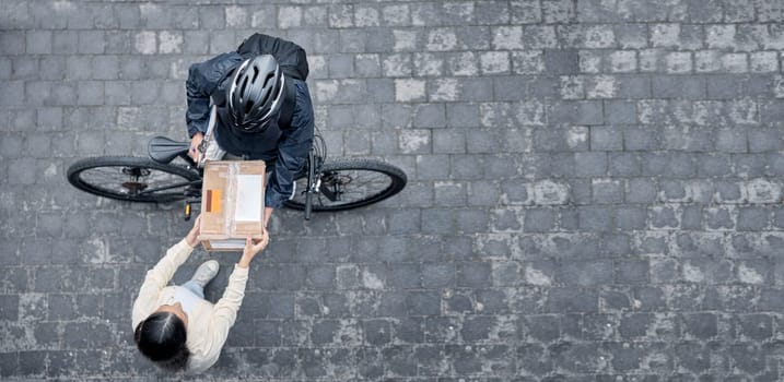 Bicycle courier, woman with box from above and package from online shopping website standing in road. Logistics, delivery and bike driver with parcel and eco friendly transport for customer in street.