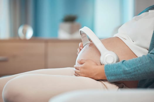 Relax music, pregnant and stomach of a woman on the sofa for peace, calm and sound for baby during pregnancy. Radio love, streaming and mother with audio therapy with headphones for child on tummy.