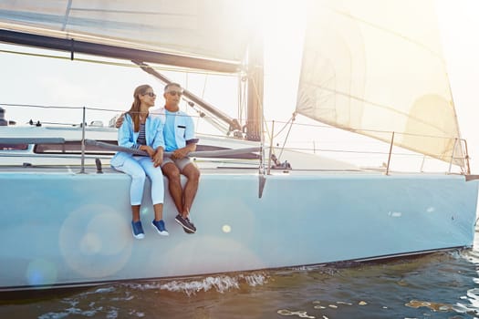 Yacht, relax and travel with a mature couple sitting on a boat out at sea for love, romance or dating together. Water, summer and ship with a man and woman enjoying a trip on the ocean while bonding.