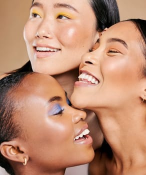 Diversity, laughing and women with happy makeup for beauty, happiness and isolated on a studio background. Skincare, smile and face of model friends with cosmetics creativity on a beige backdrop.