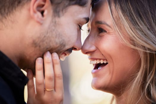 Couple, forehead touch and laugh together with happiness, comic moment or romance outdoor for date. Man, woman and funny time with love, care or happy in nature closeup with hand, face and crazy joke.