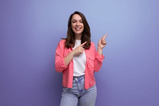nice looking european brunette 30s woman in pink shirt with inspiration on studio background with copy space.