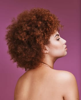 Woman, shoulder or afro hairstyle on isolated purple background in empowerment, curly maintenance or skincare salon. Beauty model, natural or hair growth texture on cosmetics studio or relax backdrop.