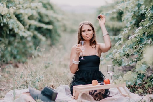 Picnic and wine tasting at sunset in the hills of Italy, Tuscany. Vineyards and open nature in the summer. Romantic dinner, fruit and wine.