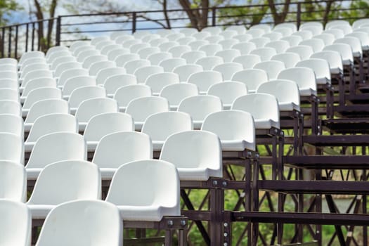 Seats of tribune on sport stadium. Concept of fans, chairs for audience, cultural environment concept. mpty seats, modern stadium