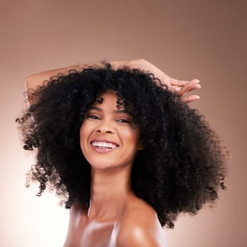 Hair, beauty and portrait of black woman with smile on brown background for wellness, shine and natural glow. Salon, luxury treatment and happy girl face with curly hairstyle, texture and afro growth.