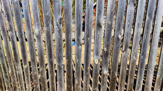 Old wooden planks in fence. Background and texture. Abstract frame and copy space. Ancient Wooden rustic rural fence