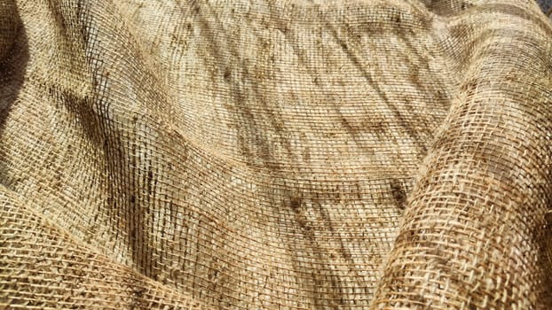 Natural fabric texture, frame and background of burlap. Rough crumpled burlap background. Selective focus