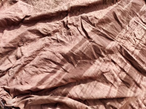Abstract background and texture of crumpled brown fabric. Texture, pattern, frame and copy space