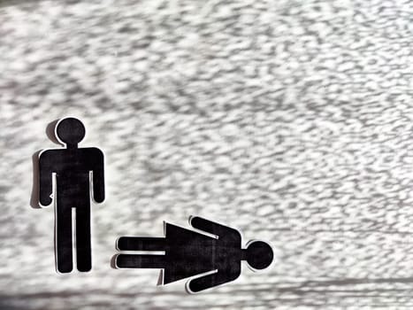Concept of abuse, death, separation, divorce, dominance in couple. Bad addiction to alcohol or drugs. Paper black figurines of man and woman and one of them dominates. Abstract background, texture