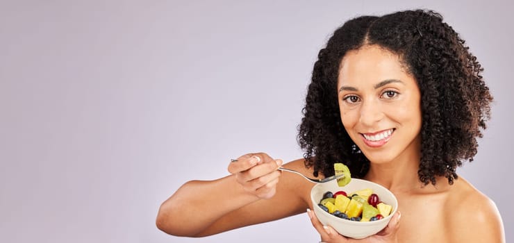 Black woman, fruit salad and studio portrait for breakfast, nutrition and smile by background. Young african, gen z model and fruits for healthy, diet and beauty mockup with energy, happiness or care.