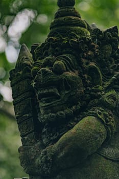 Stone sculpture in sacred monkey forest. Balinese architecture carved stone, monkey sanctuary decoration statue