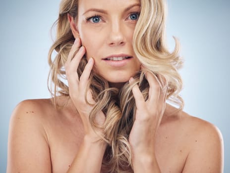 Beauty, hair care and face portrait of woman in studio isolated on a background. Haircare, keratin cosmetics or female model with curly hairstyle after salon treatment for growth, texture or balayage.