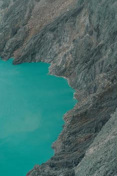 Top view of blue lake in the mountains. Scenic beautiful view of lagoon surrounded by hills