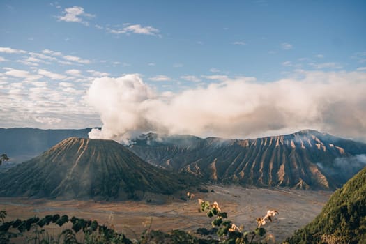 Landscape view of misty mount Bromo volcano. Foggy morning in the java national park with mount Semeru