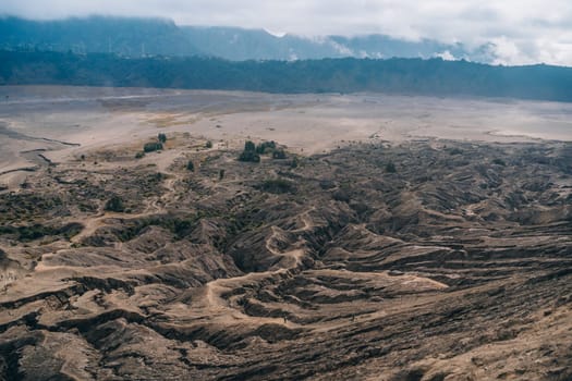 Mount Bromo volcano dry lava texture. Semeru mountain and volcanic landscape view