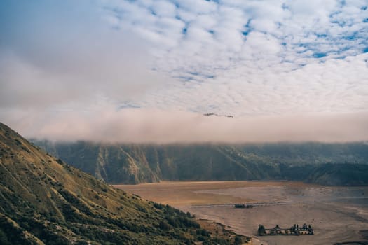 Amazing landscape view of mount bromo with cliff in fog. Morning mist in Semeru National Park