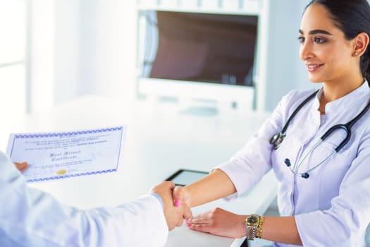 Doctor shakes hands with a patient isolated on white background.