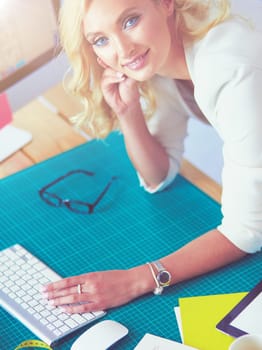 Fashion designer woman working on her designs in the studio