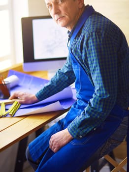 Architect working on drawing table in office.