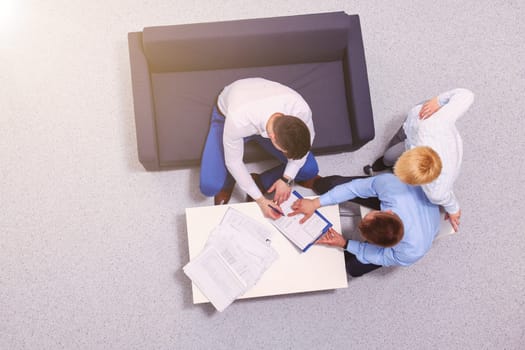 Business people sitting and discussing at meeting, in office.