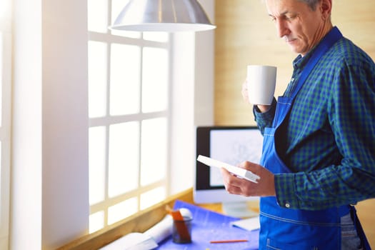 Architect working on drawing table in office.