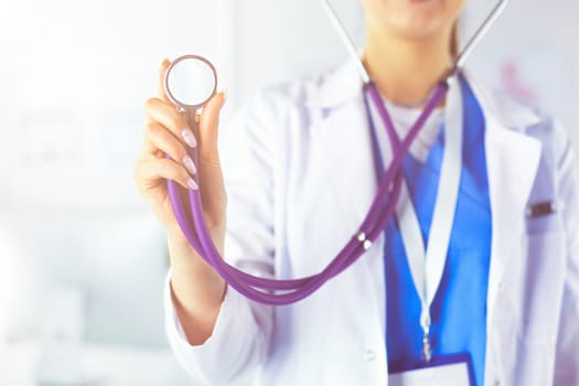 Smiling medical doctor woman with stethoscope in hospital.