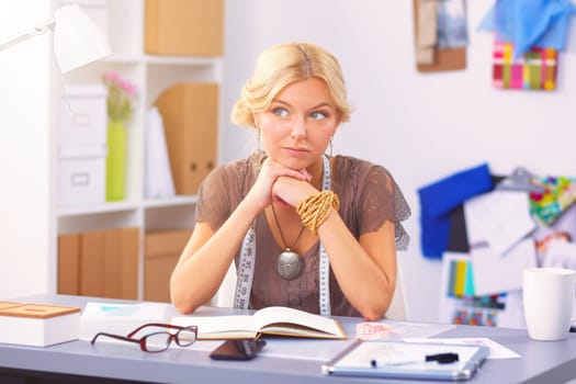 Young womamn fashion designer working at studio