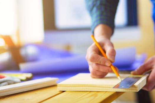 Architect working on drawing table in office.