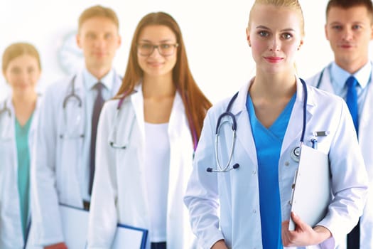 Portrait of group of smiling hospital colleagues standing together .