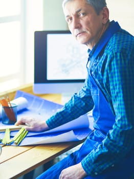 Architect working on drawing table in office.