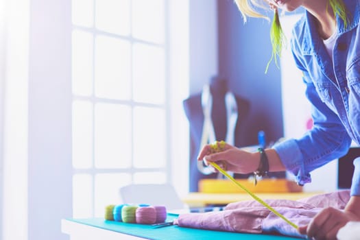 Fashion designer woman working on her designs in the studio.