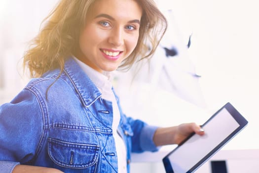 Portrait of beautiful business woman working at her desk with headset and laptop.