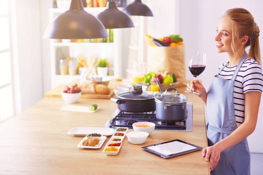 Beautiful young woman cooking in kitchen at home.