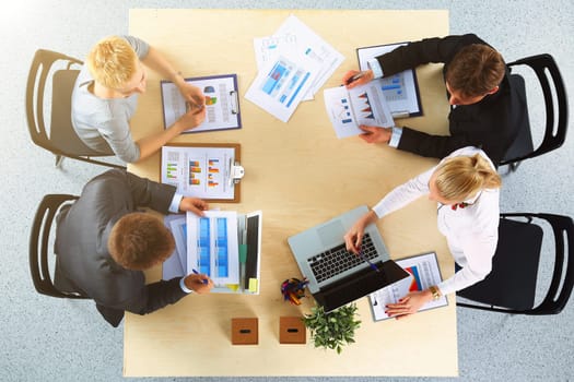 Business people sitting and discussing at business meeting, in office.