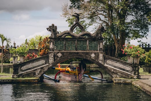 Saraswati temple bridge architecture. Ubud Water Palace, trip on pond boat, hindu temple