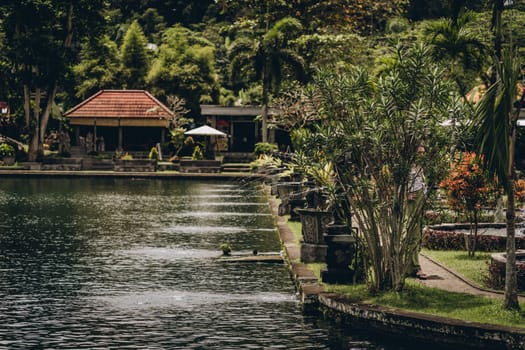 Amazing view of Saraswati lush garden with pond. Balinese architecture and tropical vegetation