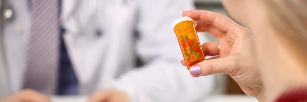 Doctor hands over medical pills to patient in clinic office. Prescribing antibiotics for pneumonia or hormone pills for women