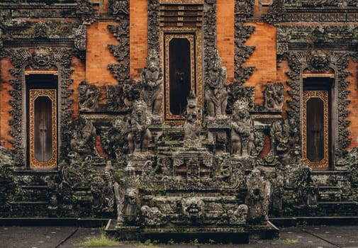 Ubud temple decorative stone statues. Balinese religious sacred architecture, stone curved sculptures