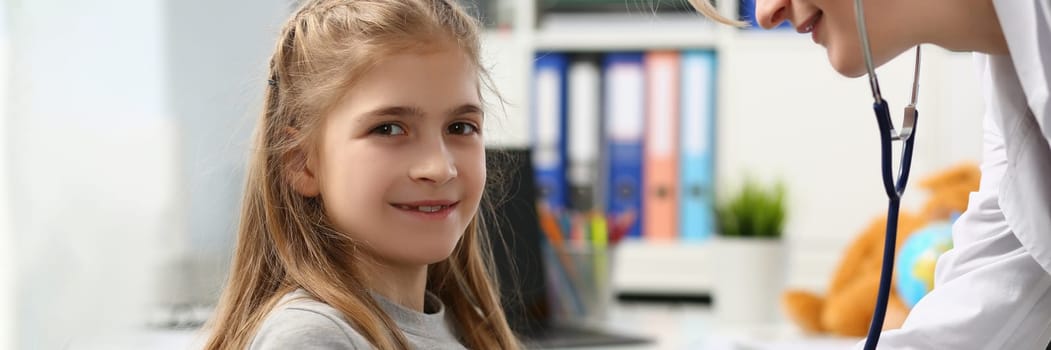 Portrait of cheerful little child at pediatrician appointment. Health care, pediatrics and medicine concept