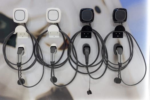 Charging handles and cables at the electric charging station. Mid shot